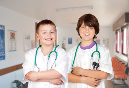 two future young doctors wearing smocks and stethoscopes