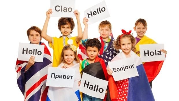 help your child learn a foreign language-kids holding hello text written in different languages