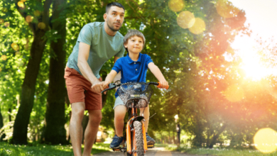 Navigating stepfatherhood - A stepdad teaching his stepson how to ride a bike.