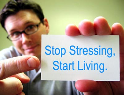 relationship stress during the holidays-a man holding a 'stop stressing, start living' text