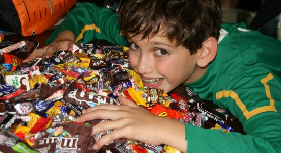 Boy in front of a big pile of candy