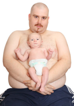 Shirtless morbidly obese man holding his baby in front of him