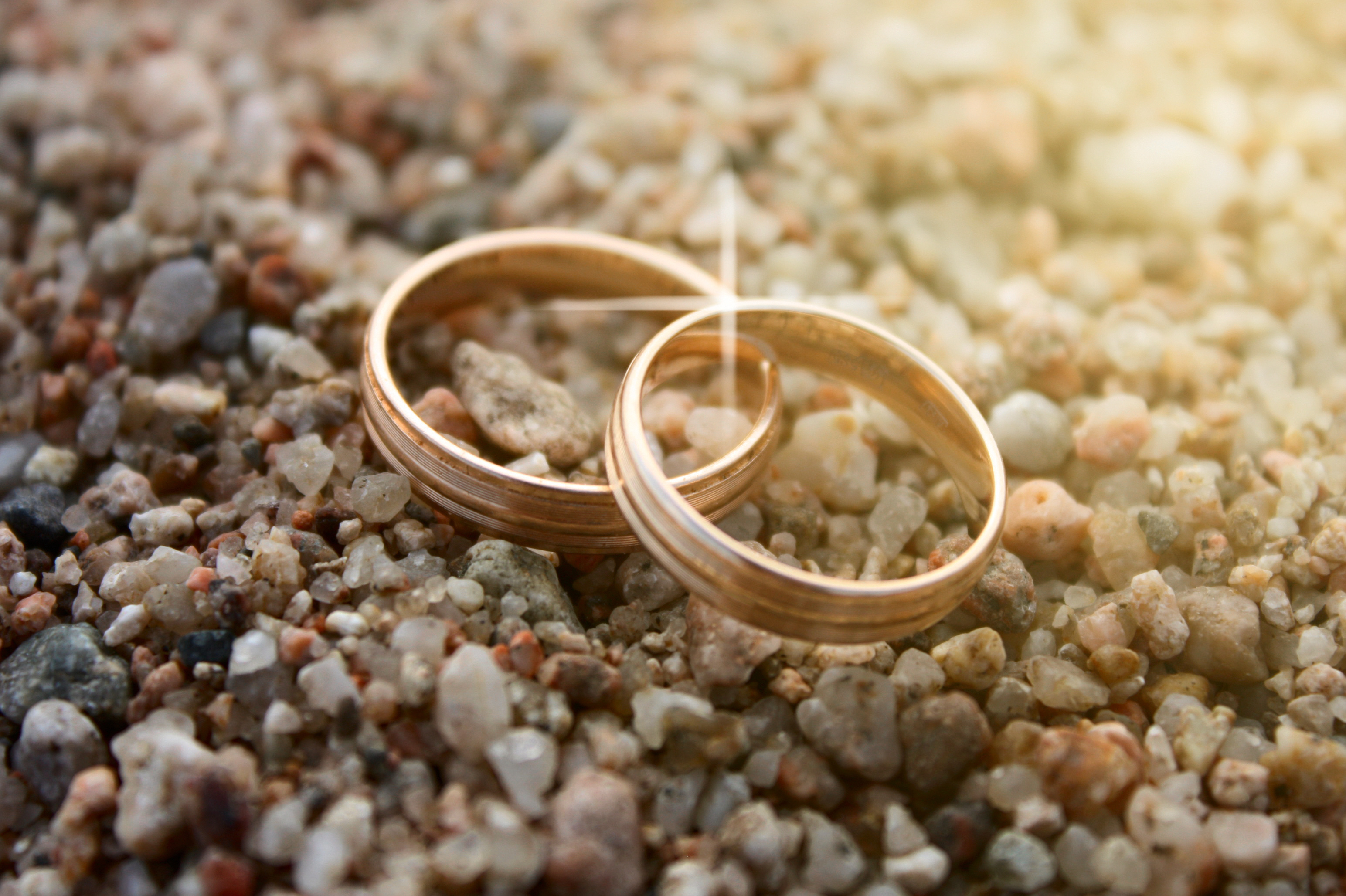 Wedding rings on sea sand. wedding rings close up