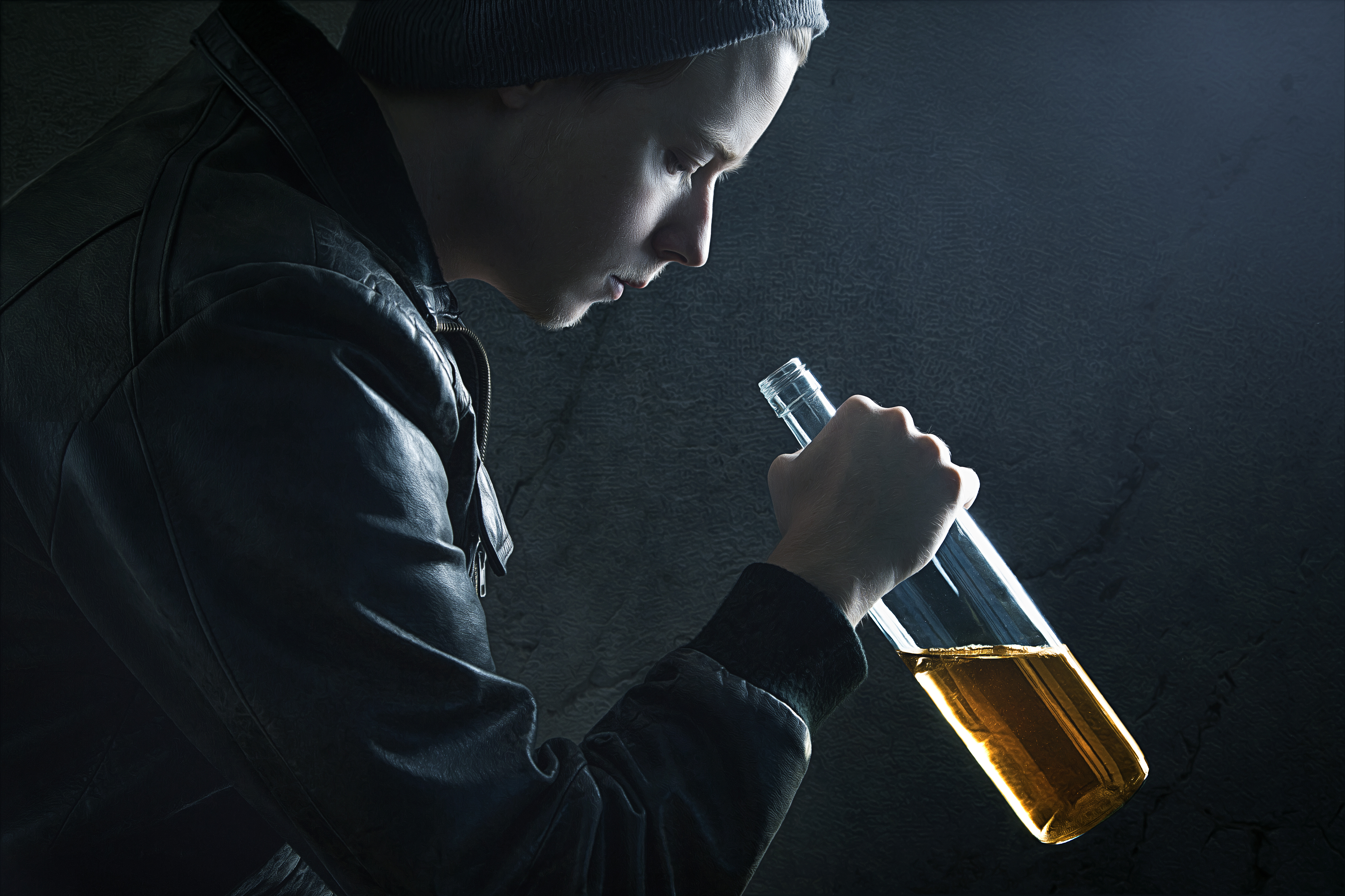 Helping a teen get back on track -teen alcohol addict preparing to take a drink