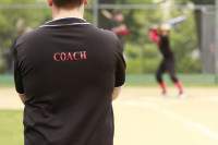 Coach watching batter about to hit