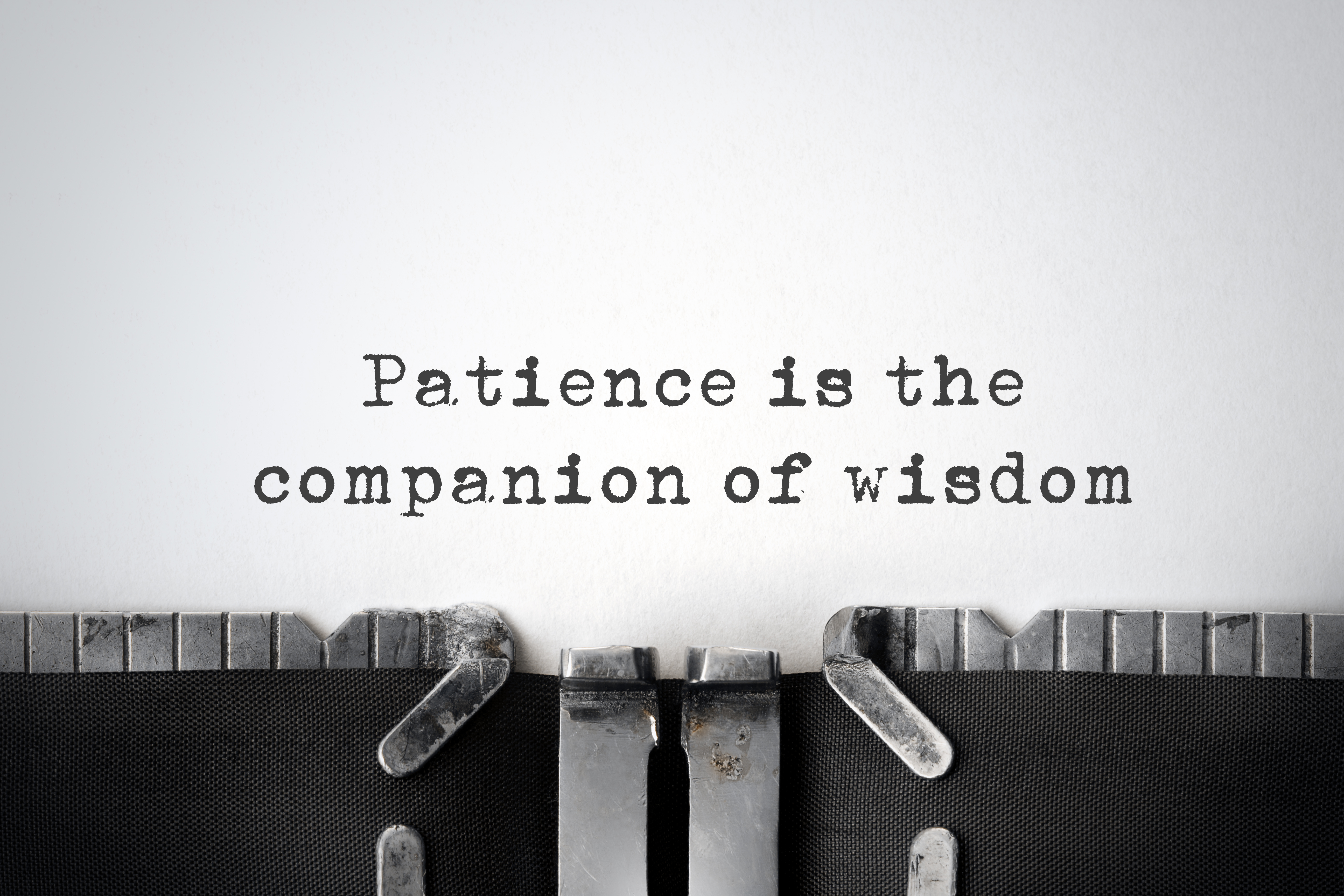 Patience Before Passion. An inspirational quote about patience typed on an old typewriter.