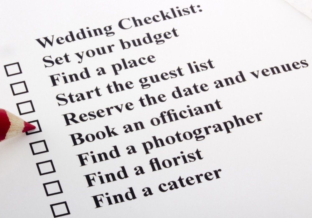 Getting married in London - London wedding planner checklist with a red pencil checking a box