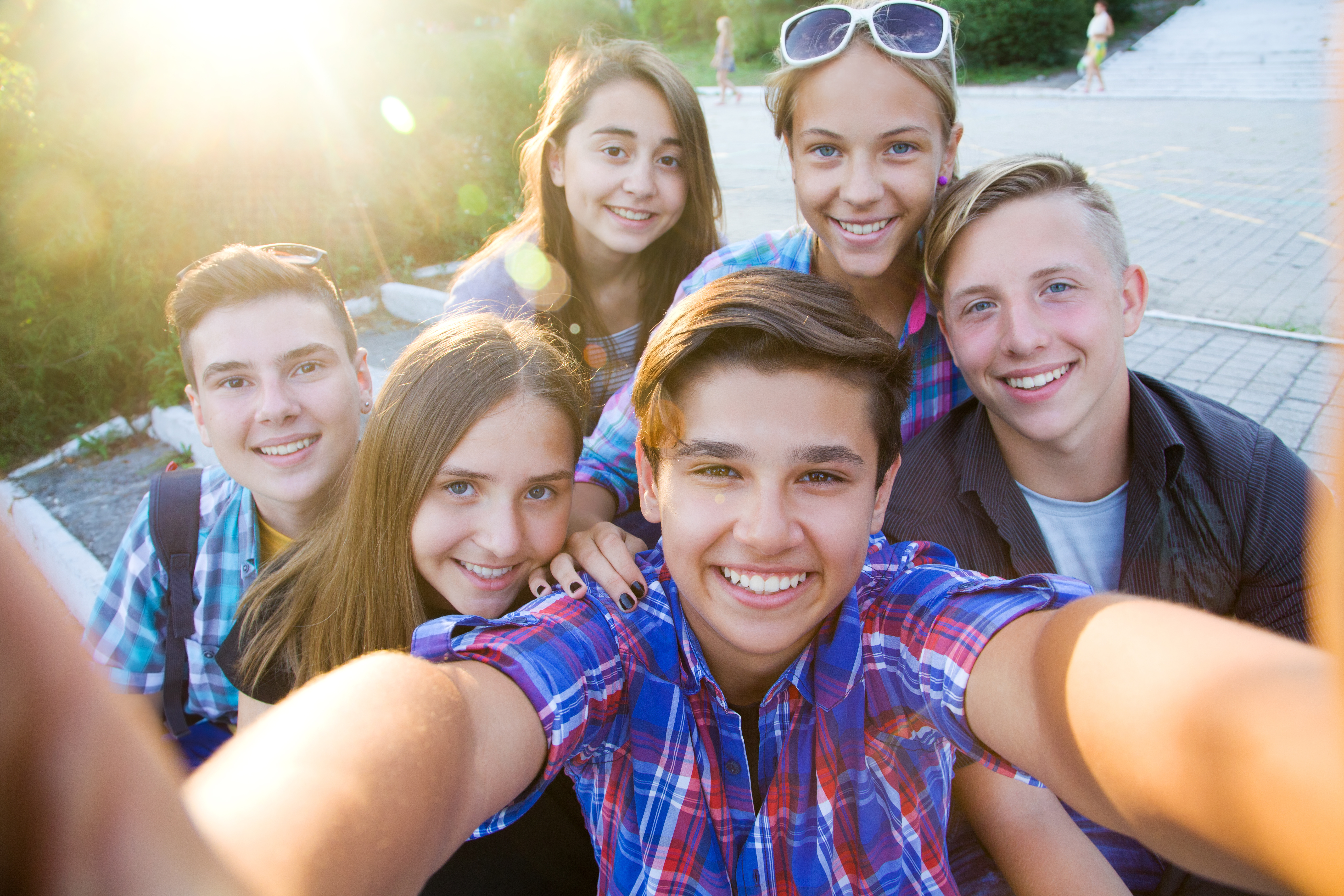 group of teenagers in the park do selfie