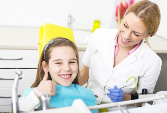 ways to make your child feel comfortable at the dentist - smiling child in dentist office