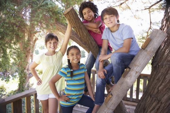 prep your backyard for kids this summer - five kids hanging out in a treehouse