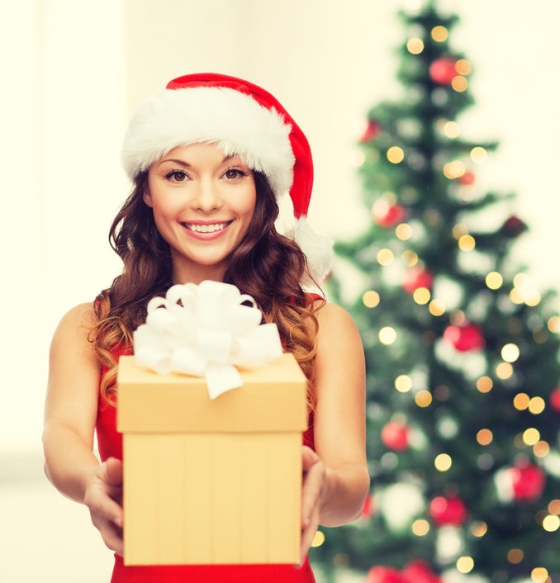Top Christmas gift ideas for men - female Santa's helper holding out a Christmas gift
