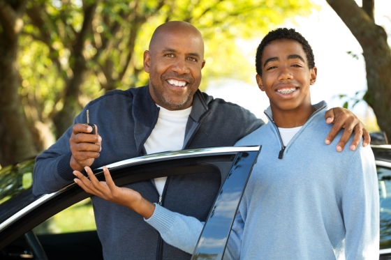 instilling safe driving skills for your teenager - stepdad and stepson next to car