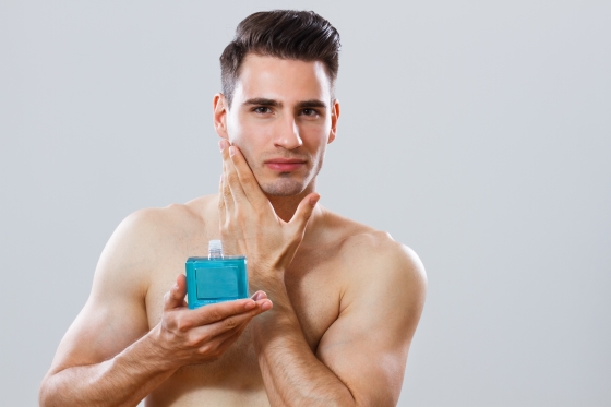 aftershave tips - picture of young man applying aftershave