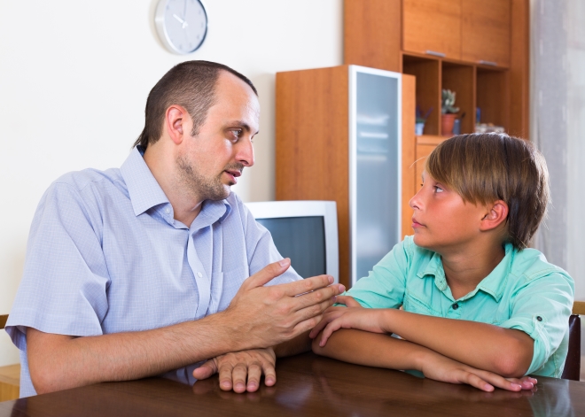 talking to your child about divorce - dad having a serious conversation with his son