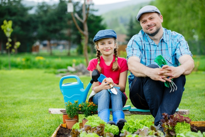 learn more about the food your family eats -girl helping stepdad in garden