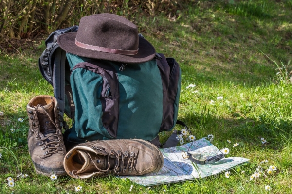 maintaining the romance in your relationship - picture of a backpack, hat, map and a pair of well-worn hiking shoes