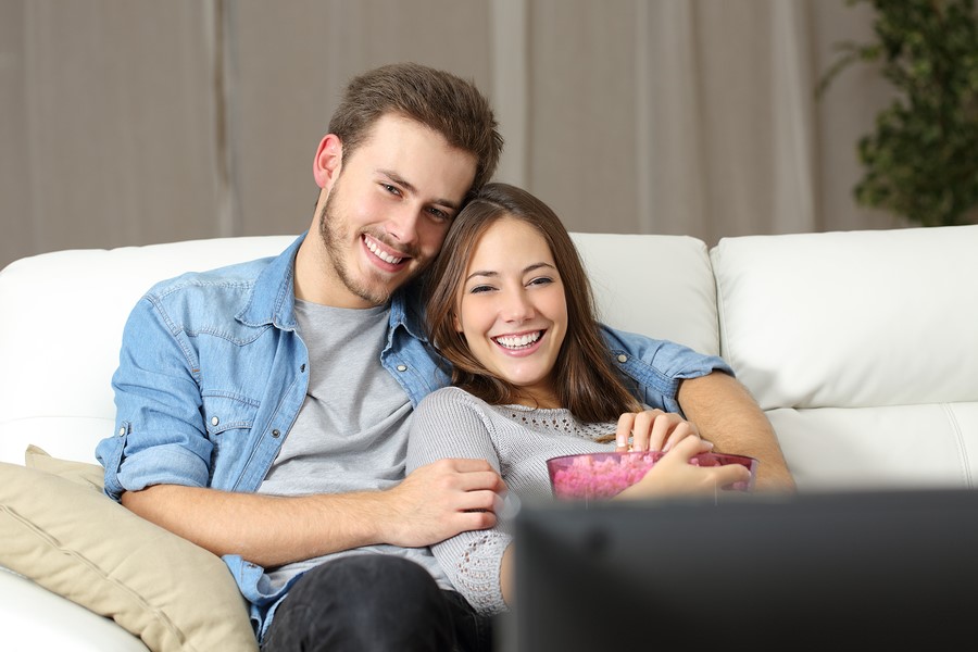 maintaining the romance in your relationship - a couple enjoying popcorn and a movie