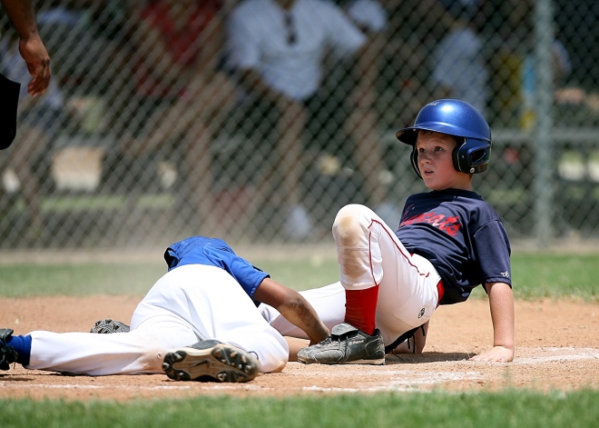 keep your athletic child injury free - picture of young baseball player sliding into base