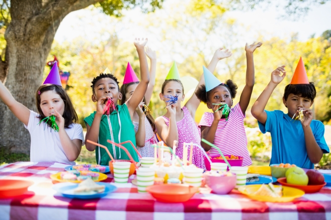 tips for planning kid's parties -Cute children having fun during a birthday party