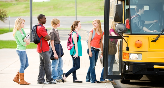 getting your kids to school - line of students boarding a school bus