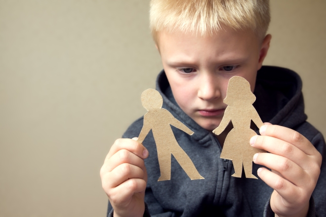 protecting your children during divorce -Confused child with paper parents