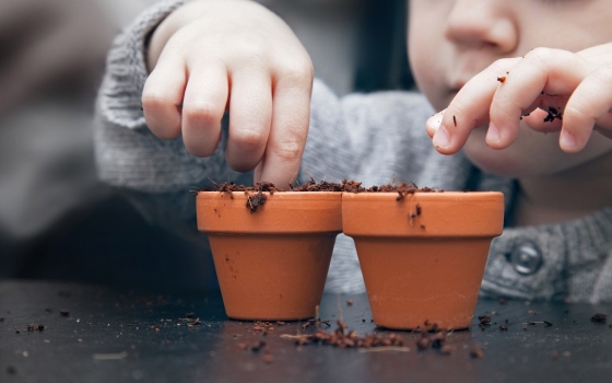 outdoor activities to help your kids develop motor skills - child planting seeds
