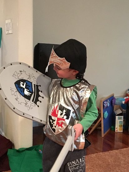 little adventures product review - Sarah's son modeling the knight's vest, shield and sword