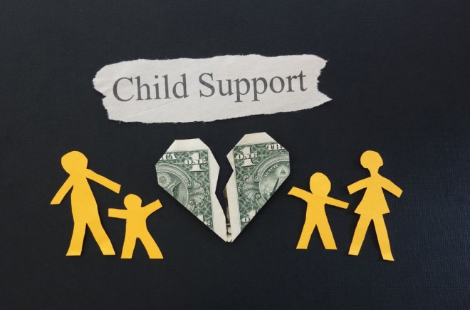 what to do about child support misuse - picture of a heart shaped dollar bill torn in the middle with a parent and child on both sides of the heart