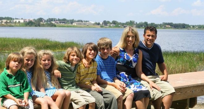 make your remarriage with kids a success -blended family sitting on a dock