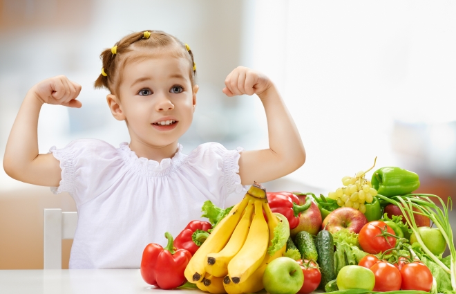 four health concerns for growing kids - cute stepdaughter realizing fruits and vegetables will make her strong
