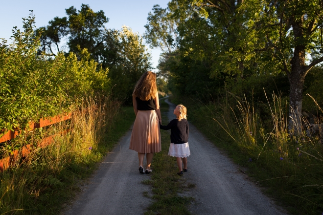 bonding with a child when it's difficult - a stepmom walking with her stepchild on a country road