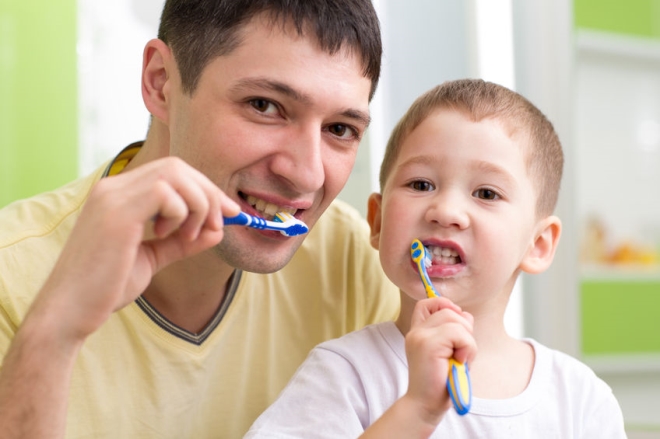 easy ways to make brushing teeth fun for kids - stepdad and son brushing teeth together