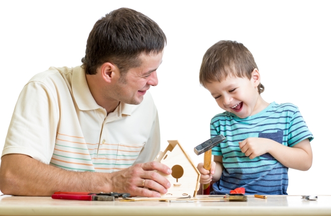 bonding with your child through woodworking - stepdad and son working on birdhouse