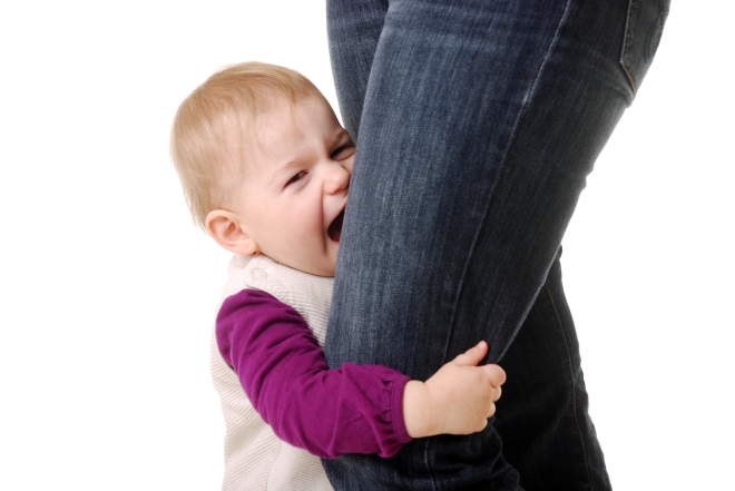 helping your child deal with separation anxiety - distressed toddler clinging to his mother's legs