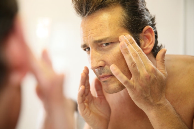 best skin care tips for men - stepdad in bathroom applying facial lotion