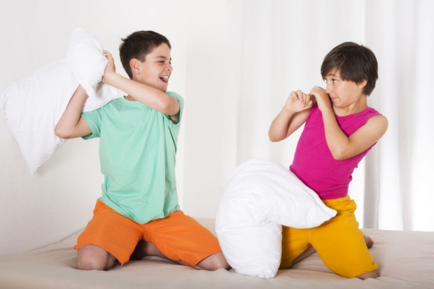 two boys having a sleepover pillow fight