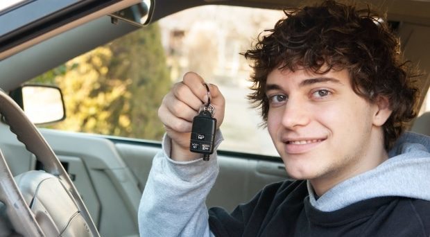 how to set rules with your teen driver - Teen driver behind the wheel with keys