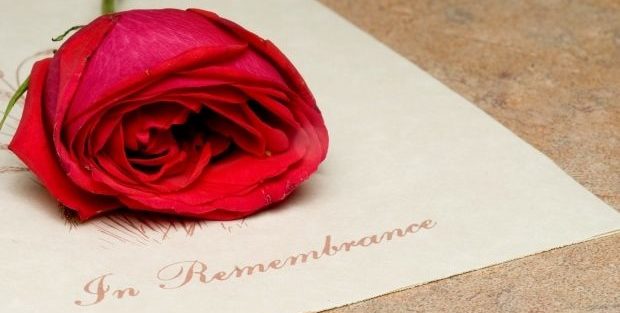 coping with the death of someone close to you - picture of a single rose lying on top of In Memoriam