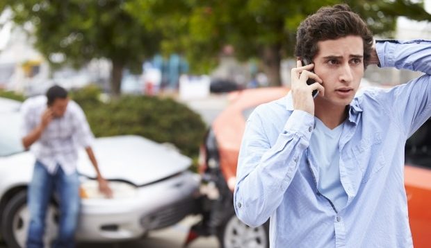 teen's first car accident - distraught teen on his cell phone involved in two car accident