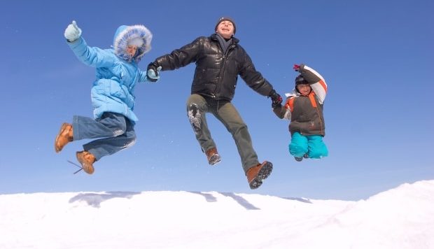 tackle any outdoor activity in the cold - family playing in the snow