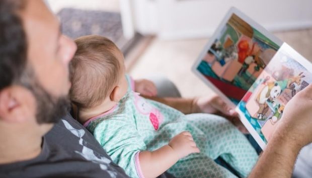 Tips To Soothe And Help Your Baby Get To Sleep - Dad reading to his baby