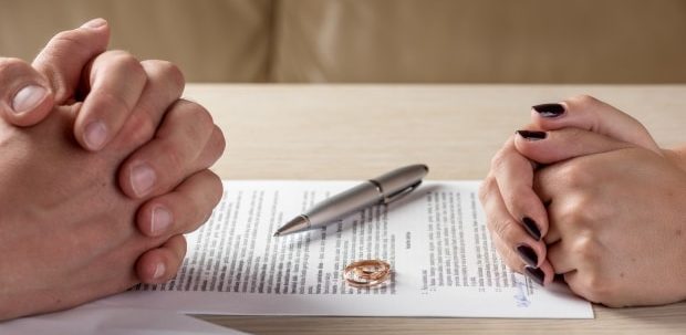 topics to understand during divorce -Wife and husband signing divorce documents