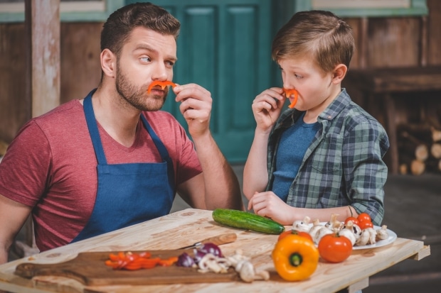 skills every dad should learn -Father in apron and cute little son having fun with pepper moustaches