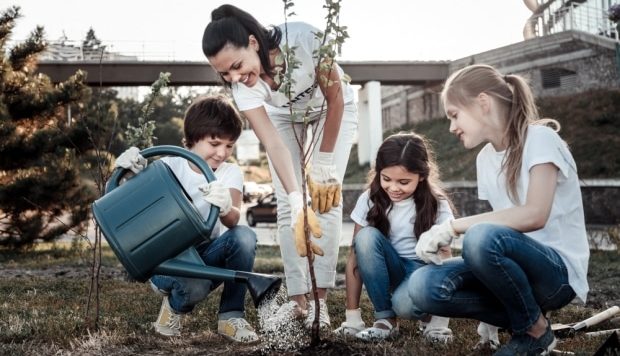 ways to teach kids to save water - family watering tree with flower pot
