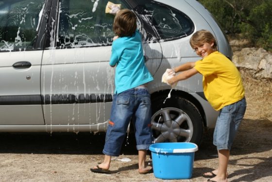 ways to teach kids to save water - kids washing van with bucket of soapy water