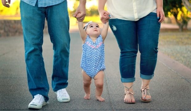 healthy habits your child learns from you - parents walking their daughter