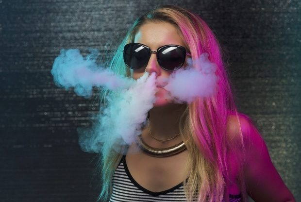 talking to your kids about vaping -Teenager vaping an electronic cigarette