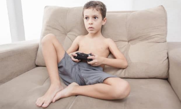 video games alternatives - Boy in a summer sunny day playing video game at home