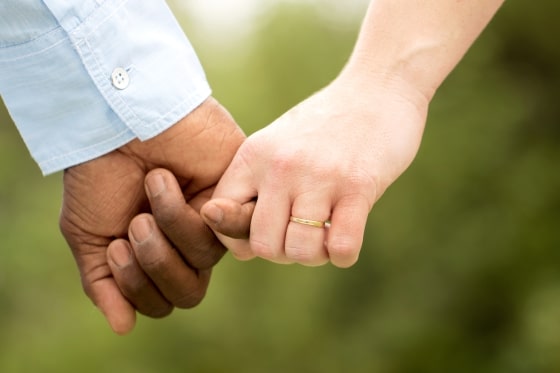 tips for successful interracial relationships - Interracial Couple Holding Hands