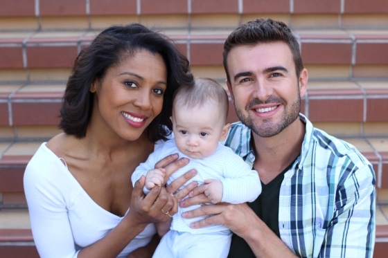 tips for successful interracial relationships - Interracial couple holding newborn